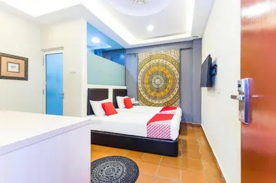 a bedroom with a bed with red pillows at OYO 90429 Hotel Narasindo in Kuala Lumpur