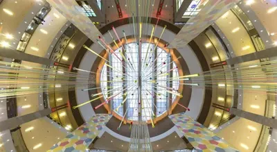 a spiral staircase in a building with a large window at Grand Barakah Hotel in Kuala Lumpur