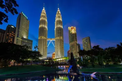 a view of the petronas towers at night at Grand Barakah Hotel in Kuala Lumpur