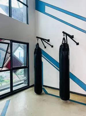 two boxing punching bags in a gym with a window at Arte Plus by Willow Trip in Ampang