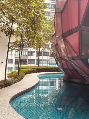 a swimming pool with a building in the background at Arte Plus by Willow Trip in Ampang