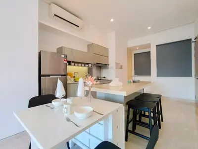 a kitchen with a table and some chairs in a room at Lucentia Residences by Manhattan Group in Kuala Lumpur