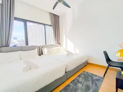 a hotel room with a bed and a chair at Lucentia Residences by Manhattan Group in Kuala Lumpur