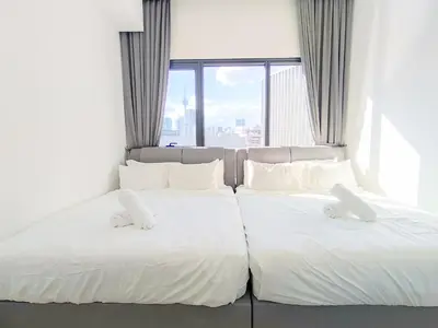 two white beds in a room with a window at Lucentia Residences by Manhattan Group in Kuala Lumpur