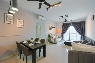 a living room with a dining table and a couch at V Residence Sunway Velocity Kuala Lumpur by Vivid Stay in Kuala Lumpur