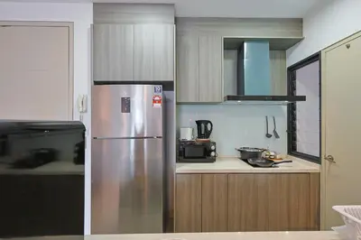 a kitchen with a stainless steel refrigerator and cabinets at V Residence Sunway Velocity Kuala Lumpur by Vivid Stay in Kuala Lumpur