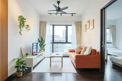 a living room with a couch and a tv at V Residence Sunway Velocity Kuala Lumpur by Vivid Stay in Kuala Lumpur