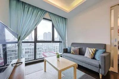a living room with a couch and a large window at V Residence Sunway Velocity Kuala Lumpur by Vivid Stay in Kuala Lumpur