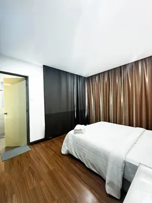 a bedroom with a large bed and a sliding glass door at Taragon Bukit Bintang City Centre in Kuala Lumpur
