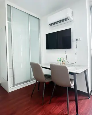 a dining room with a table and chairs and a tv at Taragon Bukit Bintang City Centre in Kuala Lumpur