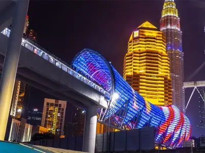 a city skyline at night with a bridge and buildings at Diamond Suite Homestay in Kuala Lumpur