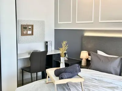 a bedroom with a bed with a chair and a desk at 8 Pax Continew 2R2B Premium Amenities 10mins to KLCC TRX in Kuala Lumpur