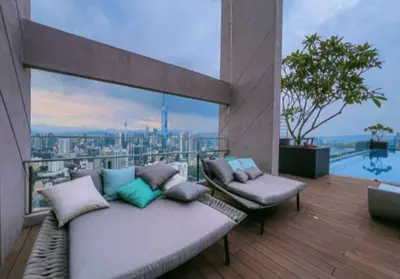 a balcony with a couch and a view of a city at The Riv at Riveria City KL Sentral KLCC view16 in Kuala Lumpur