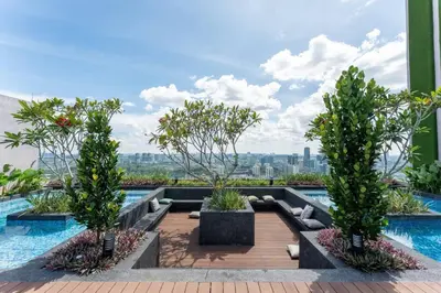 a swimming pool with three trees on top of a building at The Riv at Riveria City KL Sentral KLCC view16 in Kuala Lumpur