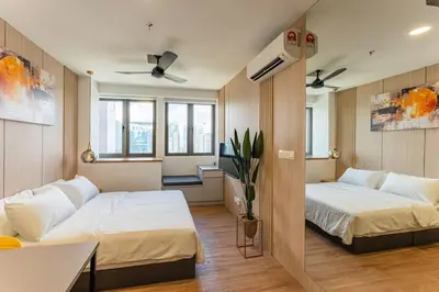 a bedroom with two beds and a living room at The Riv at Riveria City KL Sentral KLCC view16 in Kuala Lumpur