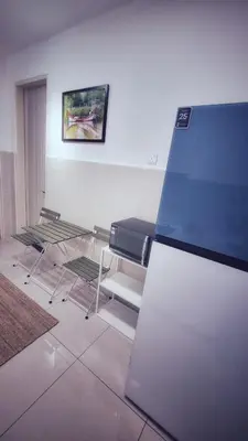 a room with four chairs and a glass table at KLCC Legasi Executive Suite Apartment in Kuala Lumpur