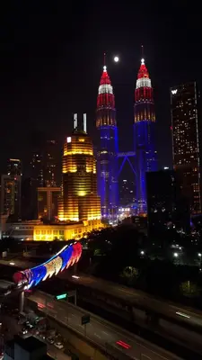 a view of a city at night with tall buildings at KLCC Legasi Executive Suite Apartment in Kuala Lumpur
