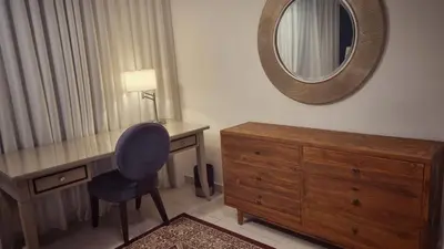 a bedroom with a desk and a mirror and a chair at KLCC Legasi Executive Suite Apartment in Kuala Lumpur