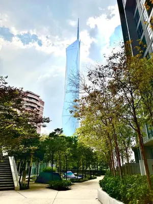 a tall glass building in a city with trees at Home Sweet Home at Robertson Bukit Bintang,TRX,KLCC in Kuala Lumpur