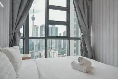 a hotel room with a bed with two towels on it at Home Sweet Home at Robertson Bukit Bintang,TRX,KLCC in Kuala Lumpur