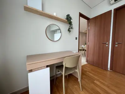 a dining room with a wooden table and a mirror at Sky Suites Charming 3BR Suite KLCC View in Kuala Lumpur