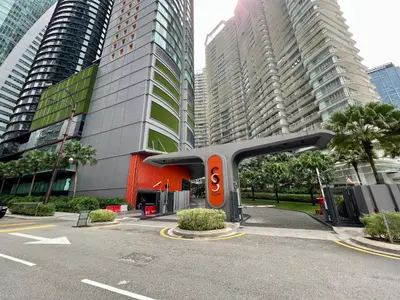 a parking lot in a city with tall buildings at Sky Suites Charming 3BR Suite KLCC View in Kuala Lumpur