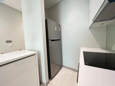 a kitchen with a refrigerator and a white counter at Sky Suites Charming 3BR Suite KLCC View in Kuala Lumpur