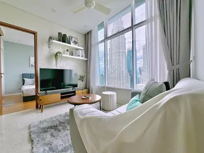 a living room with a large window and a tv at Sky Suites Wonder 2BR Suite KLCC View in Kuala Lumpur
