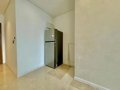 a empty room with a refrigerator in the corner at Sky Suites Wonder 2BR Suite KLCC View in Kuala Lumpur