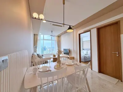 a dining room with a table and chairs in a room at Sky Suites Upper 3BR Suite at KLCC in Kuala Lumpur