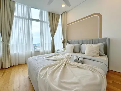 a bedroom with a large bed with two pillows on it at Sky Suites Upper 3BR Suite at KLCC in Kuala Lumpur