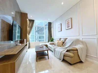 a living room with a couch and a tv at Sky Suites Unique 3BR Suite KLCC View in Kuala Lumpur