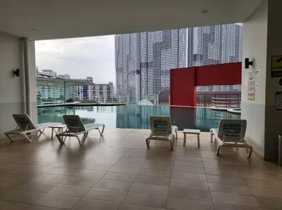 a room with chairs and a glass table in a building at Désir Amorous KL #Jacuzzi #NFLX #Prjscn120