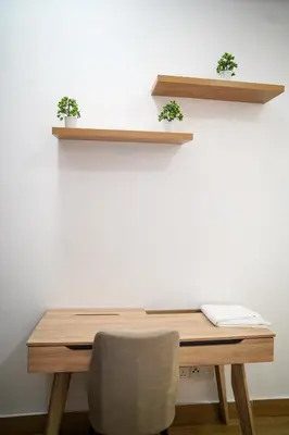 a wooden table with two shelves on a wall at Klcc view residences in Kuala Lumpur