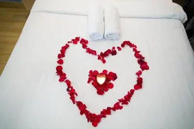 a heart made out of roses on a bed at Klcc view residences in Kuala Lumpur
