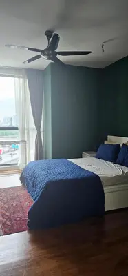a bedroom with a bed with a ceiling fan at City Centre Apartment in Kuala Lumpur