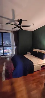 a bedroom with a ceiling fan and a bed at City Centre Apartment in Kuala Lumpur