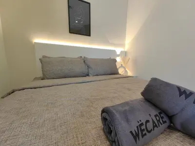 a bedroom with a large bed with a blanket at X - The Thomas Bangsar South Midvalley LRT Kerinchi in Kuala Lumpur