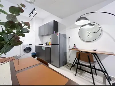 a kitchen with a desk and a refrigerator at KIcc view residences by the colony in Kuala Lumpur