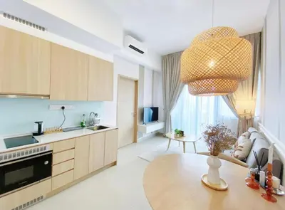 a kitchen with a table and a large chandelier at KIcc view residences by the colony in Kuala Lumpur