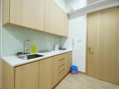 a kitchen with wooden cabinets and a sink at The colony by infinitum sweet home in Kuala Lumpur