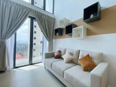 a living room with a couch and a large window at The colony by infinitum sweet home in Kuala Lumpur