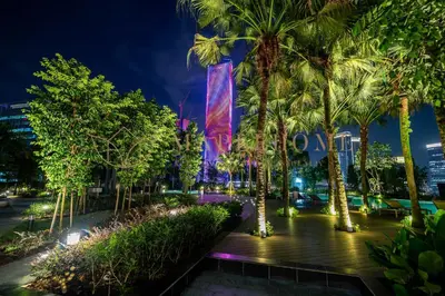 a city street with palm trees at night at Agile Premier Suites Kuala Lumpur in Kuala Lumpur