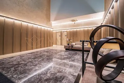 a bathroom with a black marble floor and wooden walls at Agile Premier Suites Kuala Lumpur in Kuala Lumpur