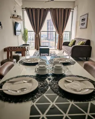 a living room with a table with plates on it at MH Platinum 2 Homestay 3Bedroom in Kuala Lumpur