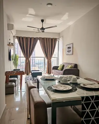 a living room with a table and a couch at MH Platinum 2 Homestay 3Bedroom in Kuala Lumpur