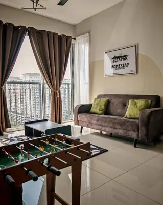 a living room with a foosball table and a couch at MH Platinum 2 Homestay 3Bedroom in Kuala Lumpur