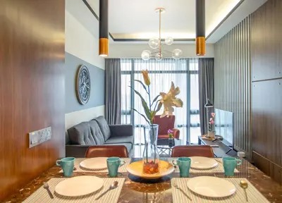 a dining room with a table and a couch at Anggun Residence near KLCC in Kuala Lumpur