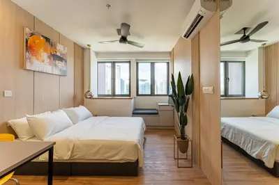 a room with two beds and a couch at The Riv at Riveria City KL Sentral by Luxe n Comfy in Kuala Lumpur