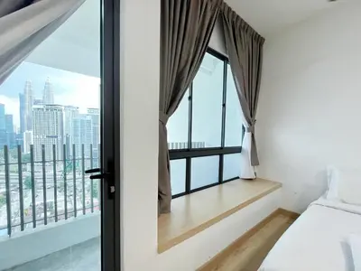 a bedroom with a window with a view of the city at The Colony Infinitum By Happy Stay in Kuala Lumpur